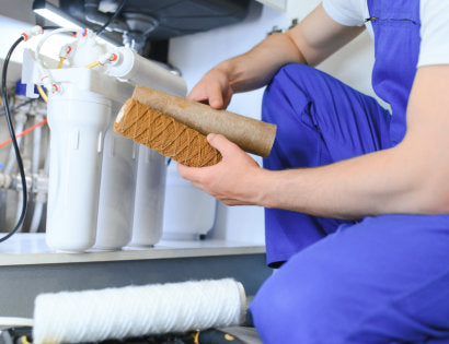 a plumber installing a water filtration system